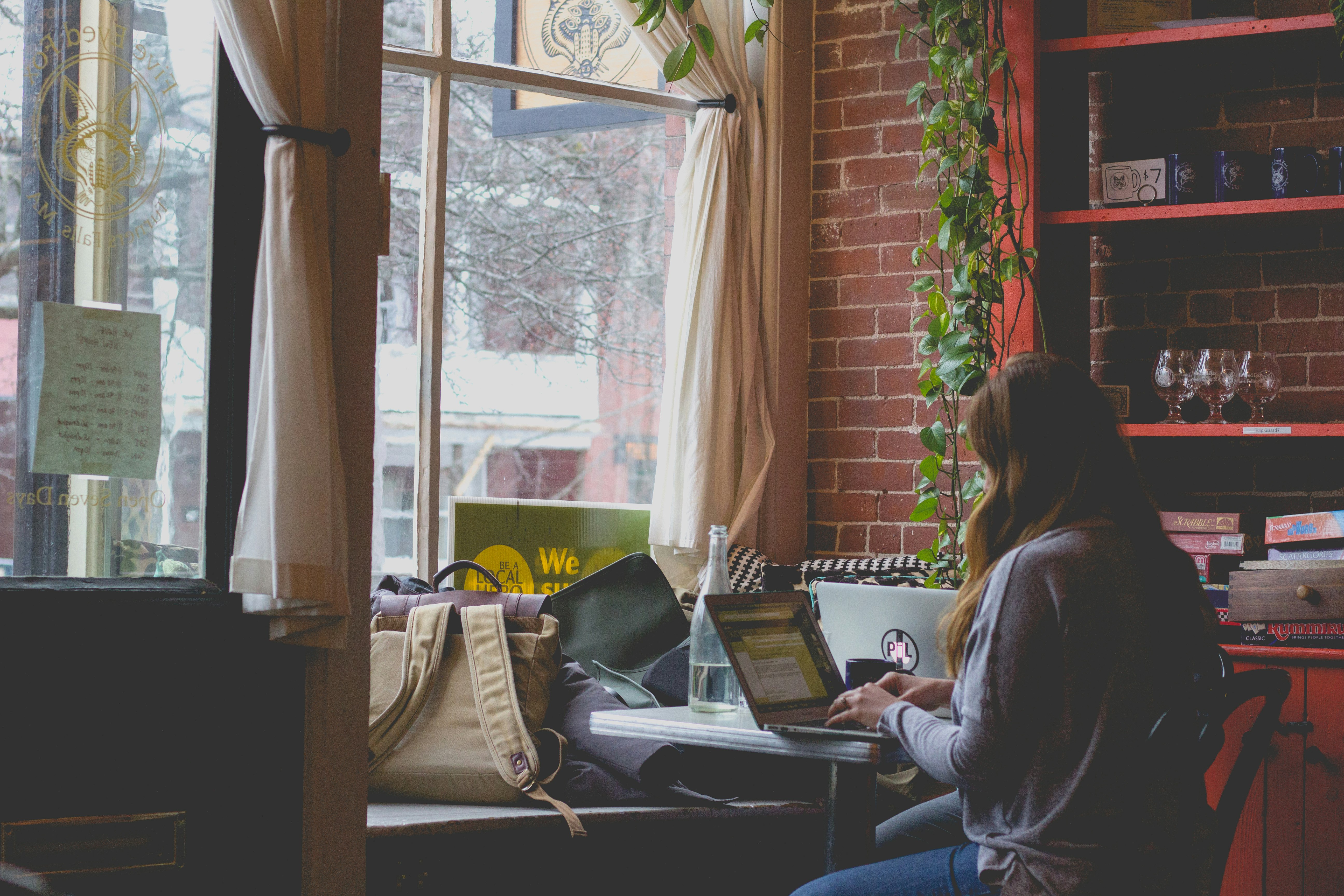 woman using computer sitting on black chair